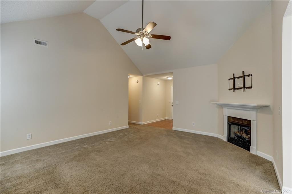 300 Springlake Road York, SC 29745 - Photo 10 of 46 a view of an empty room with chandelier fan and fire place