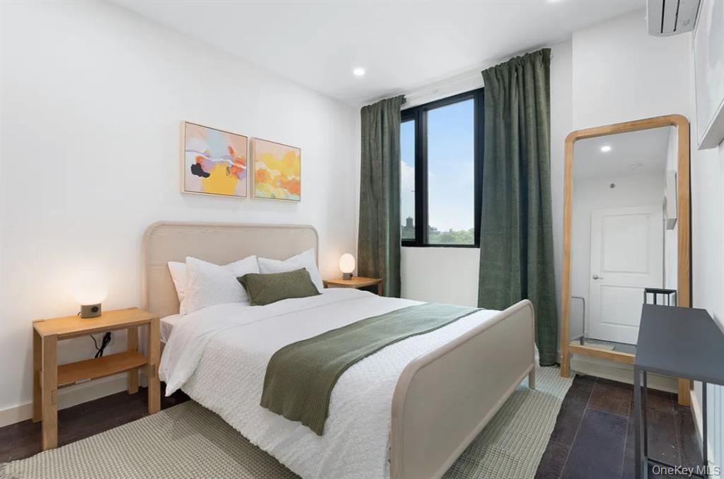 124-28 Queens Boulevard, Unit 9D Queens, NY 11415 - Photo 11 of 14 Bedroom with recessed lighting and an AC wall unit