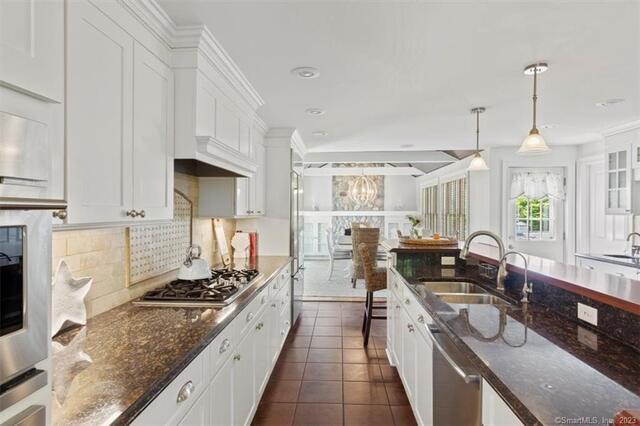 47 Brighton Road Old Lyme, CT 06371 - Photo 11 of 39 a kitchen with granite countertop a sink a counter top space appliances and cabinets