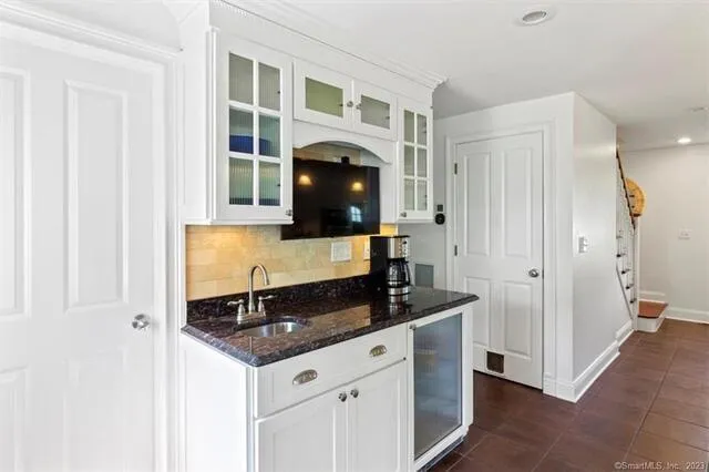 a kitchen with granite countertop a sink and a cabinets