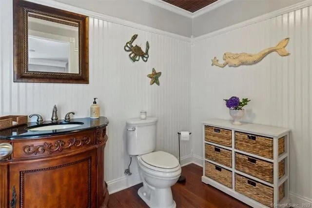 a bathroom with a toilet a sink and mirror