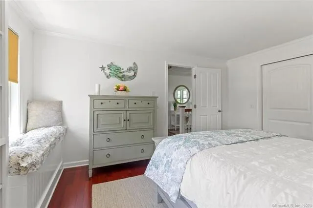 a bedroom with a bed and a dresser