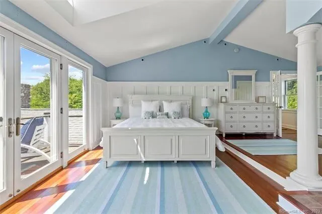 a spacious bedroom with a bed and a large window