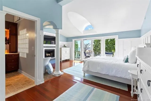 a bedroom with a bed and a view of living room