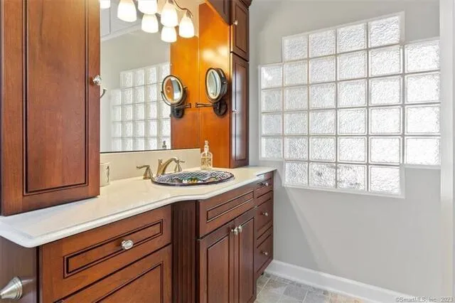 a kitchen with a sink cabinets and a window