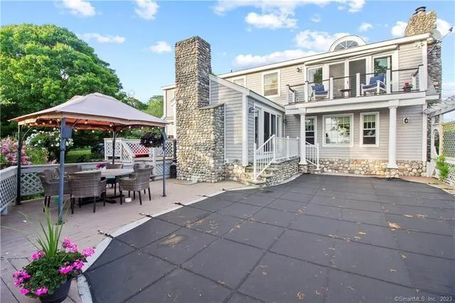 a view of a patio with a table and chairs under an umbrella