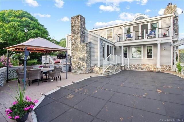47 Brighton Road Old Lyme, CT 06371 - Photo 32 of 39 a view of a patio with a table and chairs under an umbrella