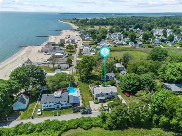 a aerial view of a house with a garden and lake view