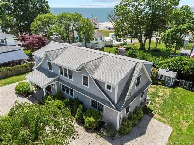 an aerial view of a house with a yard and potted plants