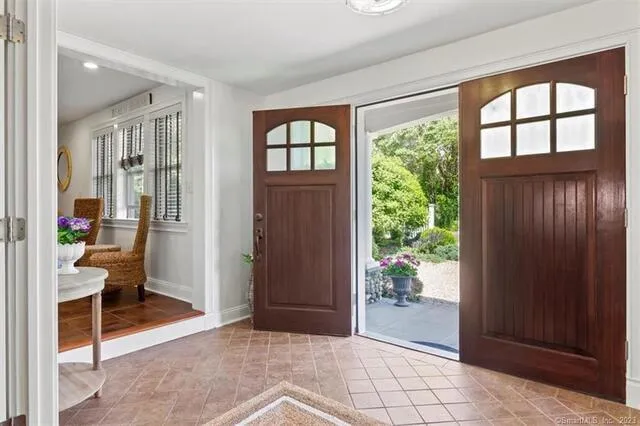 a view of a livingroom with wooden floor and a bedroom