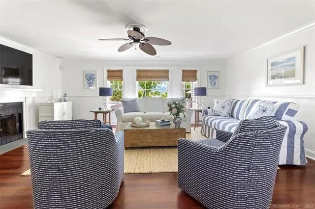 a living room with furniture fireplace and flat screen tv