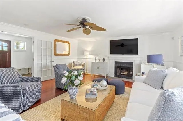 a living room with furniture a flat screen tv and a fireplace