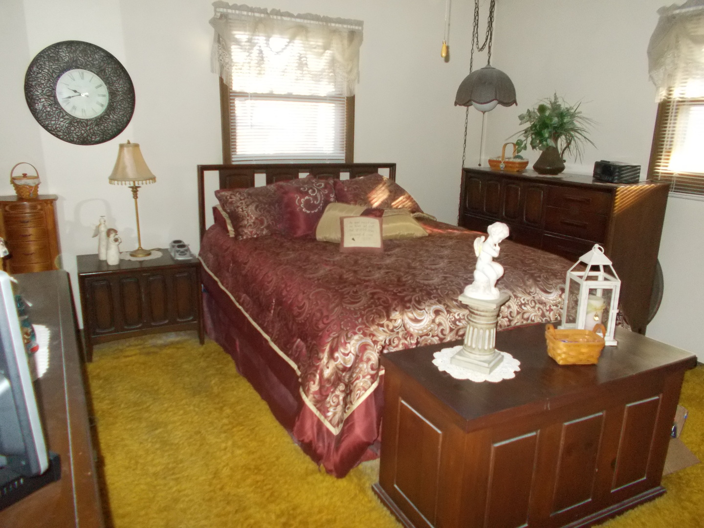 905 Winthrop Court Zion, IL 60099 - Photo 5 of 13 a bed sitting in a bedroom next to a window with a chandelier