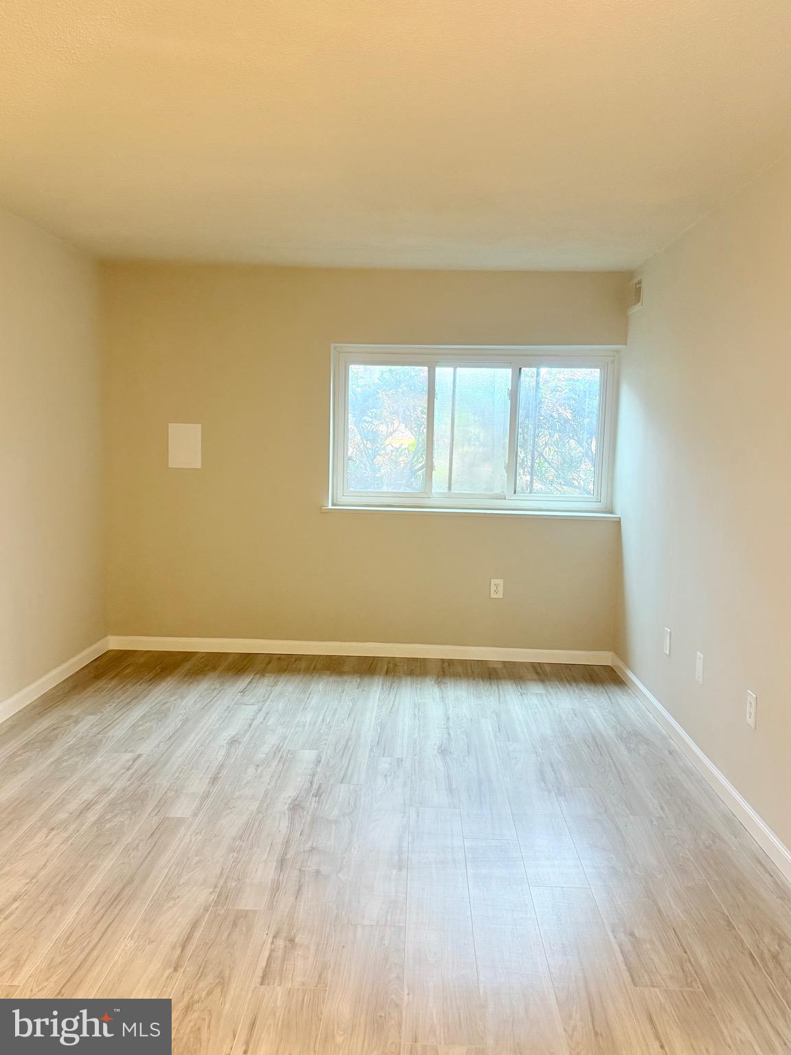11739 Ledura Court, Unit T7 Reston, VA 20191 - Photo 14 of 17 an empty room with wooden floor and windows