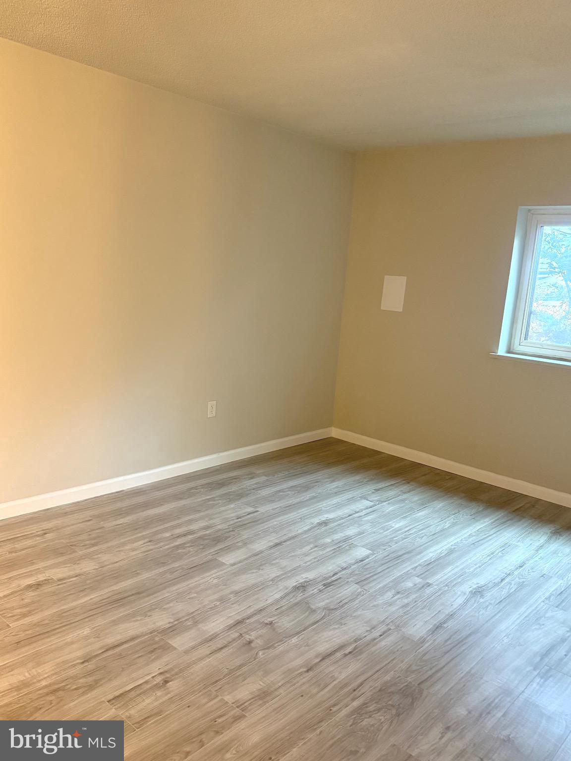 11739 Ledura Court, Unit T7 Reston, VA 20191 - Photo 15 of 17 a view of an empty room with wooden floor and a window