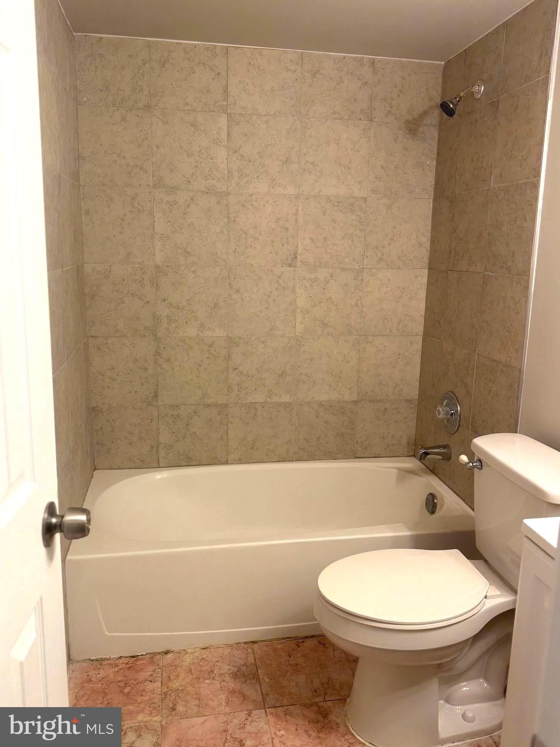 11739 Ledura Court, Unit T7 Reston, VA 20191 - Photo 16 of 17 a bathroom with a toilet and a bath tub