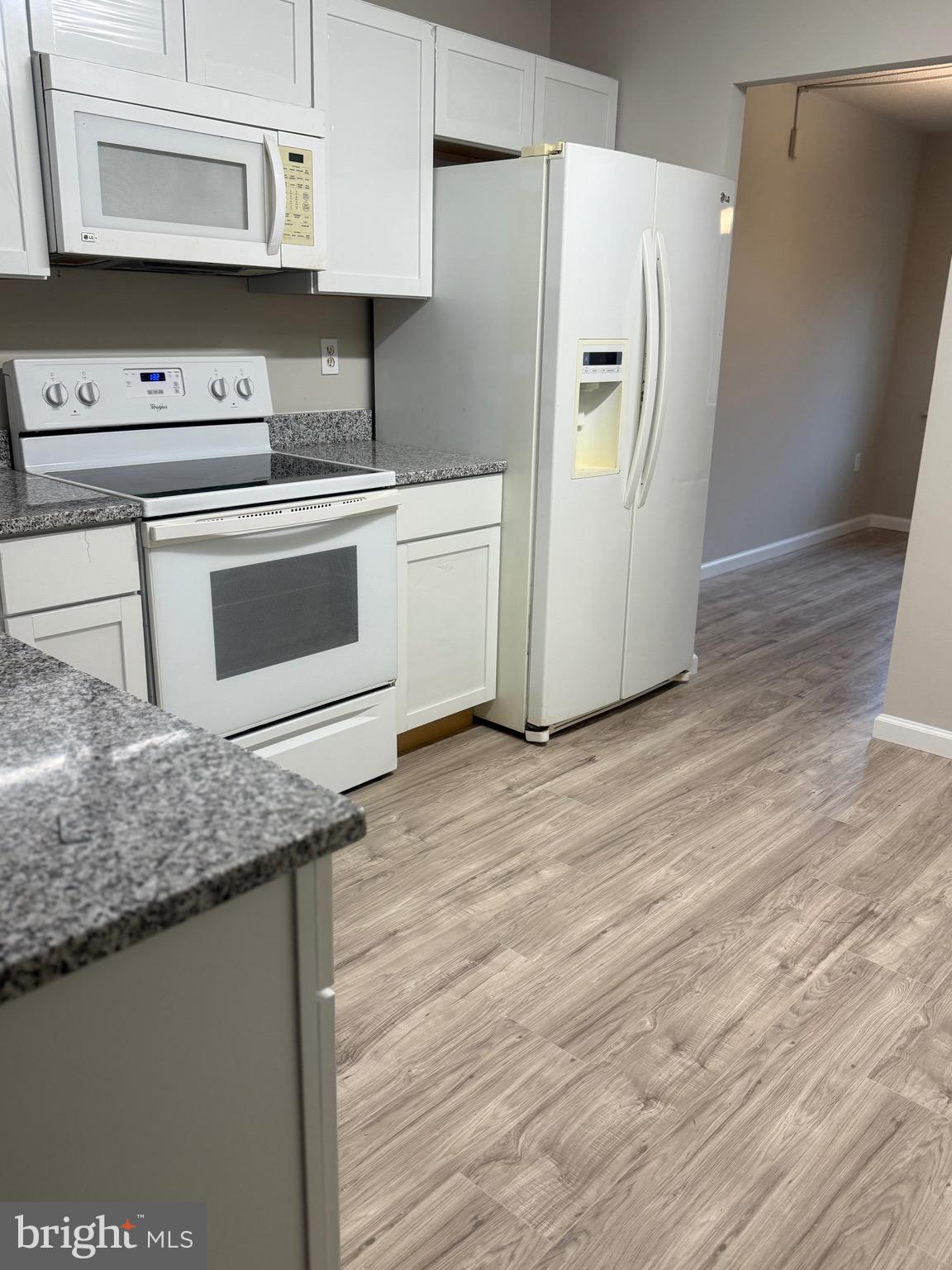 11739 Ledura Court, Unit T7 Reston, VA 20191 - Photo 7 of 17 a kitchen with stainless steel appliances granite countertop a refrigerator and a stove
