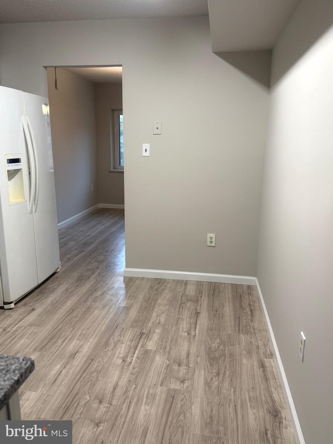 11739 Ledura Court, Unit T7 Reston, VA 20191 - Photo 9 of 17 a view of an empty room with wooden floor and a window