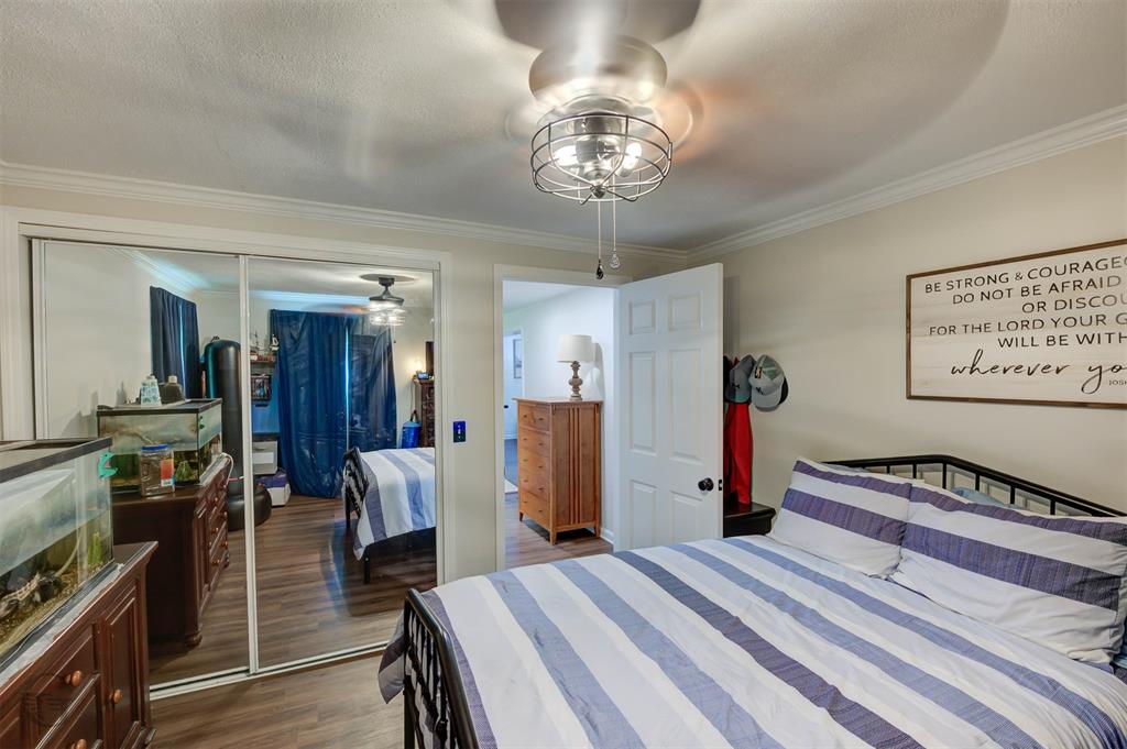 701 Chandler Road Haughton, LA 71037 - Photo 13 of 25 a bedroom with a bed and a chandelier