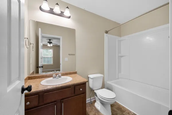a bathroom with a sink toilet mirror and shower