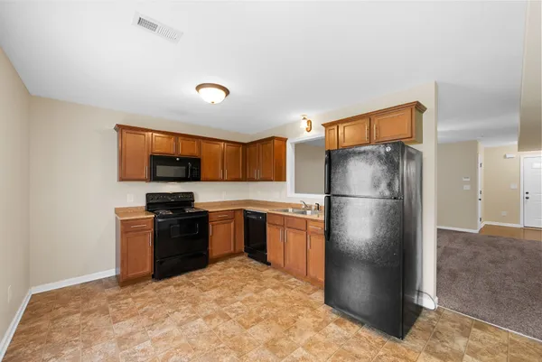 a kitchen with stainless steel appliances granite countertop a refrigerator stove and microwave