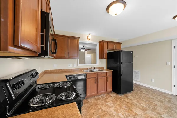 a kitchen with stainless steel appliances granite countertop a stove a refrigerator and a sink
