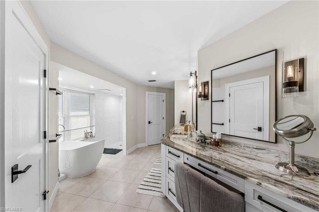 4724 Riverside Drive Estero, FL 33928 - Photo 16 of 44 a bathroom with a double vanity sink and mirror