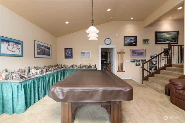 a living room with furniture and a book shelf
