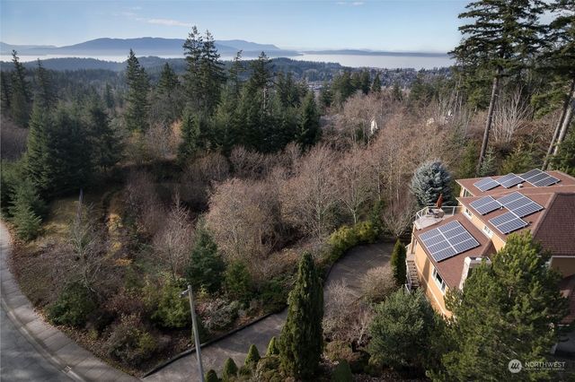 an aerial view of house with yard and outdoor seating