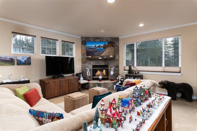 a living room with furniture a flat screen tv and a fireplace