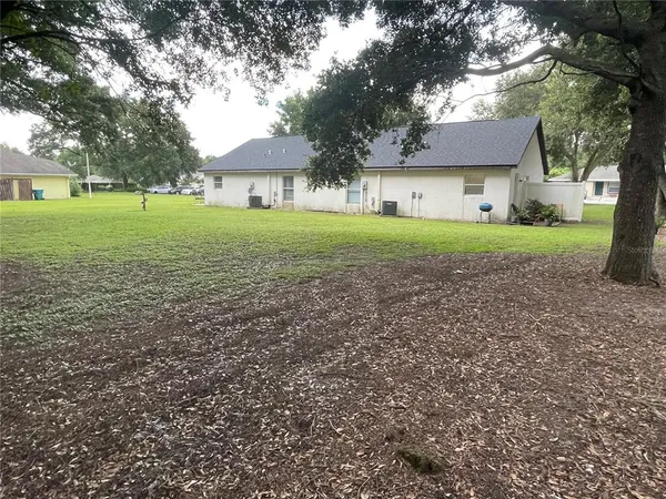 a view of house with backyard
