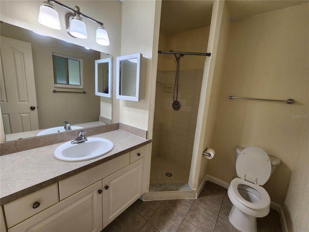 501 Southwest 75th Street, Unit A14 Gainesville, FL 32607 - Photo 39 of 56 a bathroom with a granite countertop sink toilet and shower