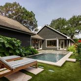 a front view of house with yard and trees in the background