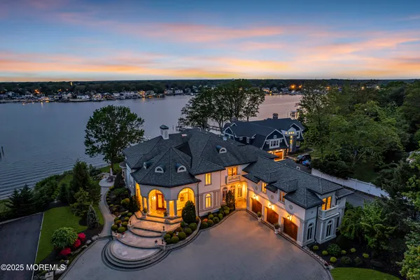 an aerial view of a house with outdoor space swimming pool and lake view