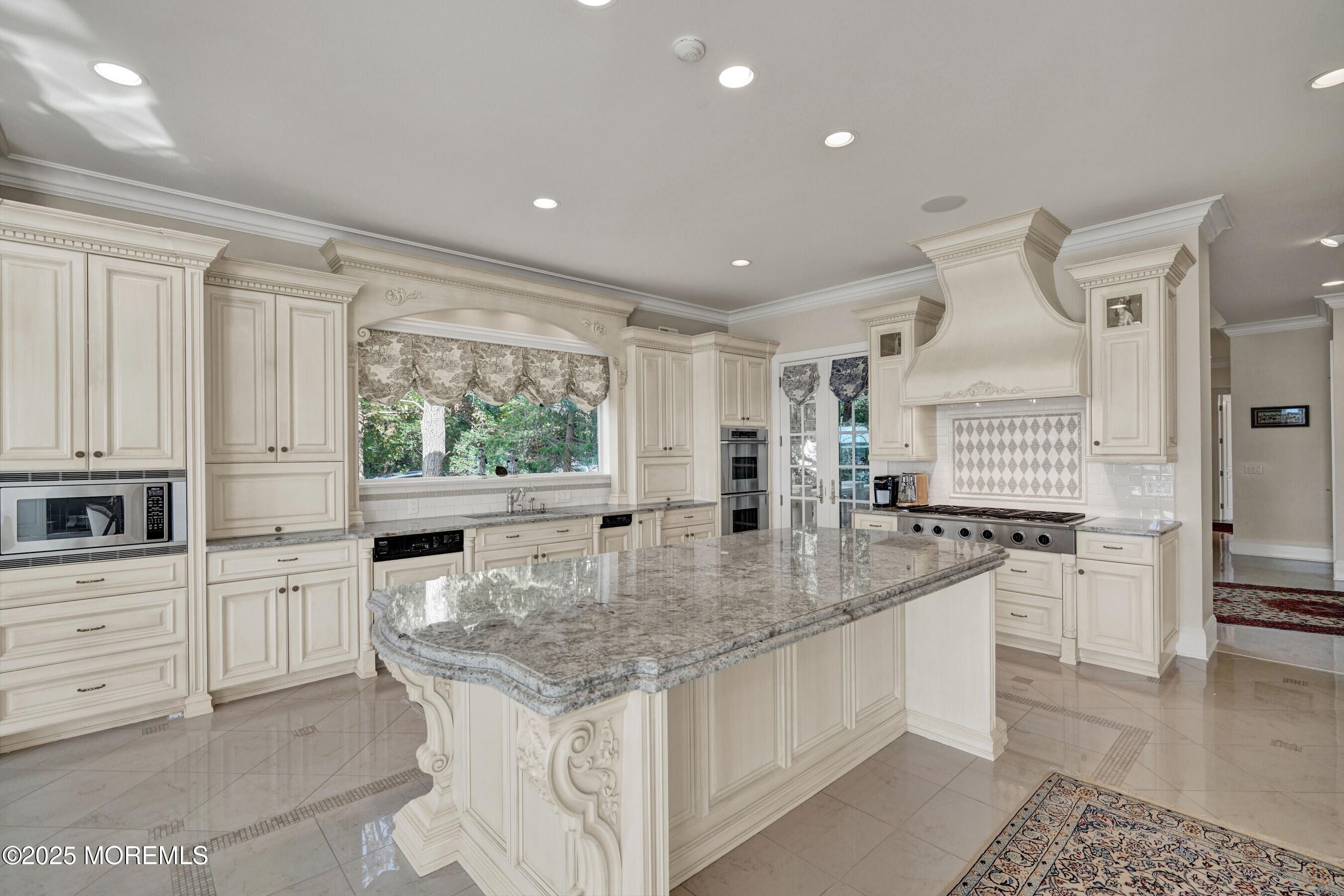 1015 Forrest Road Brielle, NJ 08730 - Photo 11 of 61 a kitchen with stainless steel appliances granite countertop a stove a sink and white cabinets with wooden floor