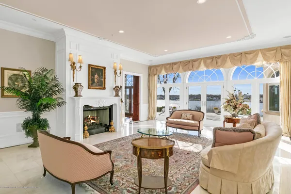 a living room with furniture a large window and a dining table
