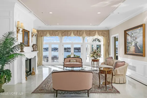 a dining room with furniture a chandelier and wooden floor