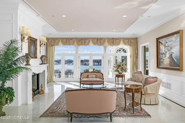 a dining room with furniture a chandelier and wooden floor