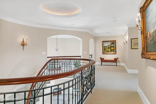 a view of residential houses with yard and ocean view