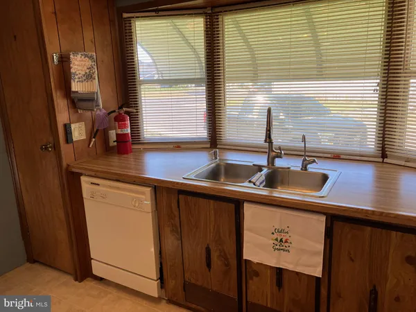 a kitchen with a sink a window and cabinets