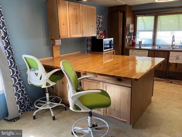 a room with table chairs and windows