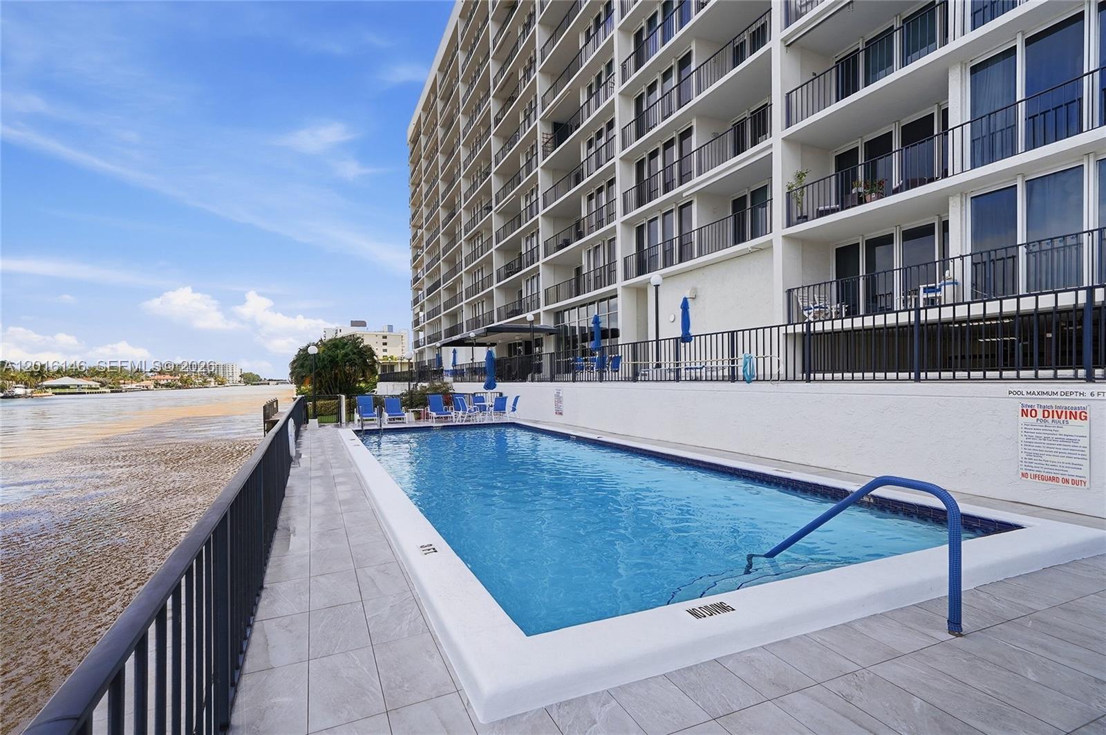 521 North Riverside Drive, Unit 606 Pompano Beach, FL 33062 - Photo 36 of 50 a swimming pool with outdoor seating and plants