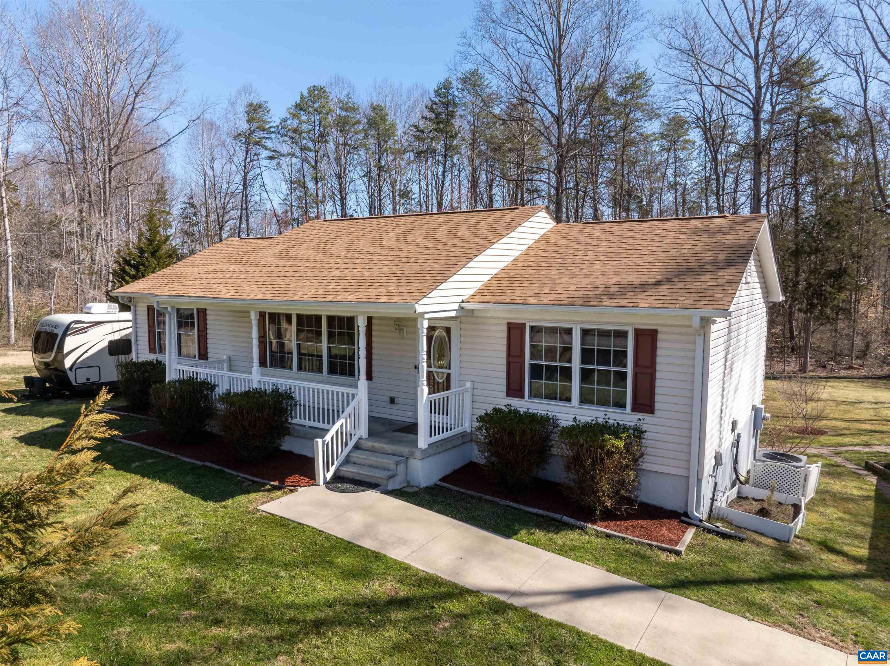 242 Fairview Road Louisa, VA 23093 - Photo 3 of 75 a front view of a house with a yard and outdoor seating