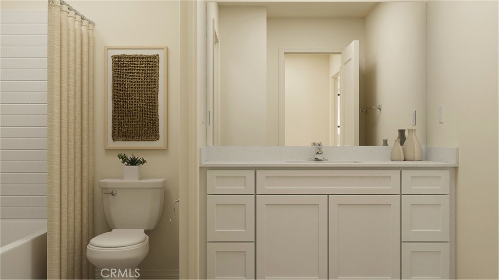 1166 Thunderchief Lane Rialto, CA 92376 - Photo 8 of 16 a bathroom with a toilet a sink a vanity and mirror