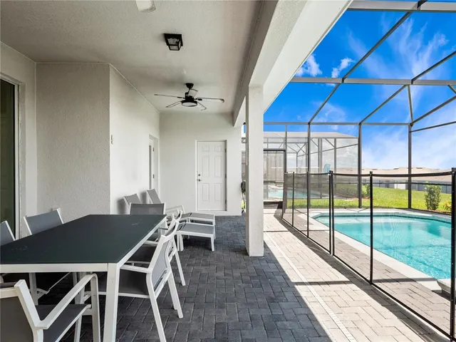 a view of a dining room with furniture large windows and wooden floor