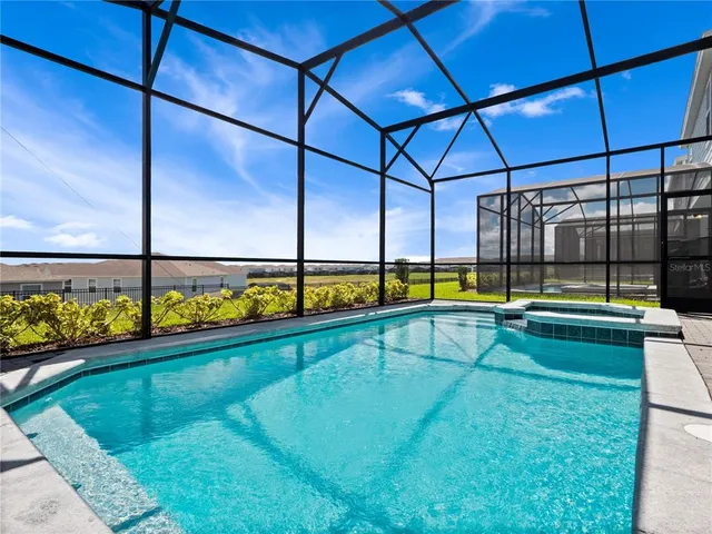 a view of a swimming pool with a bench and couch