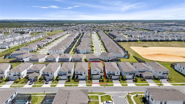 an aerial view of residential houses with outdoor space