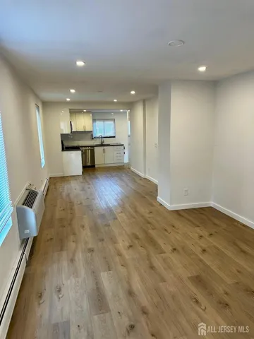 a view of kitchen and hall with wooden floor