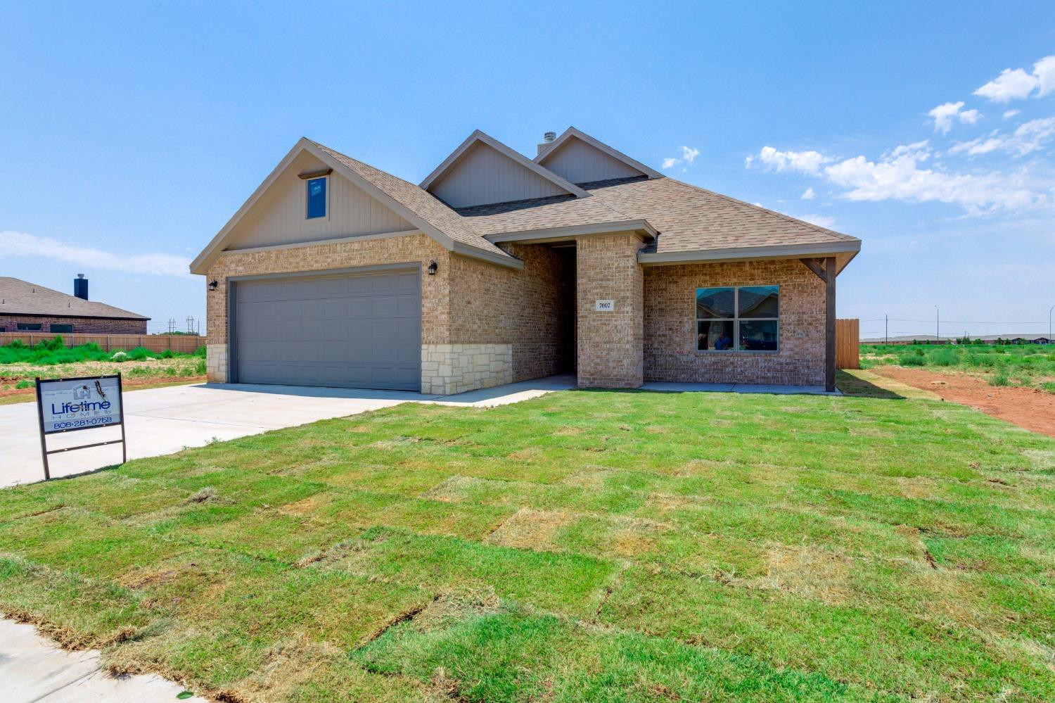 7007 18th Street Lubbock, TX 79416 - Photo 2 of 34 a front view of house with yard and garage