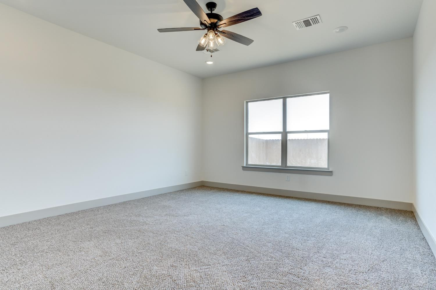 7007 18th Street Lubbock, TX 79416 - Photo 24 of 34 an empty room with a window and a ceiling fan